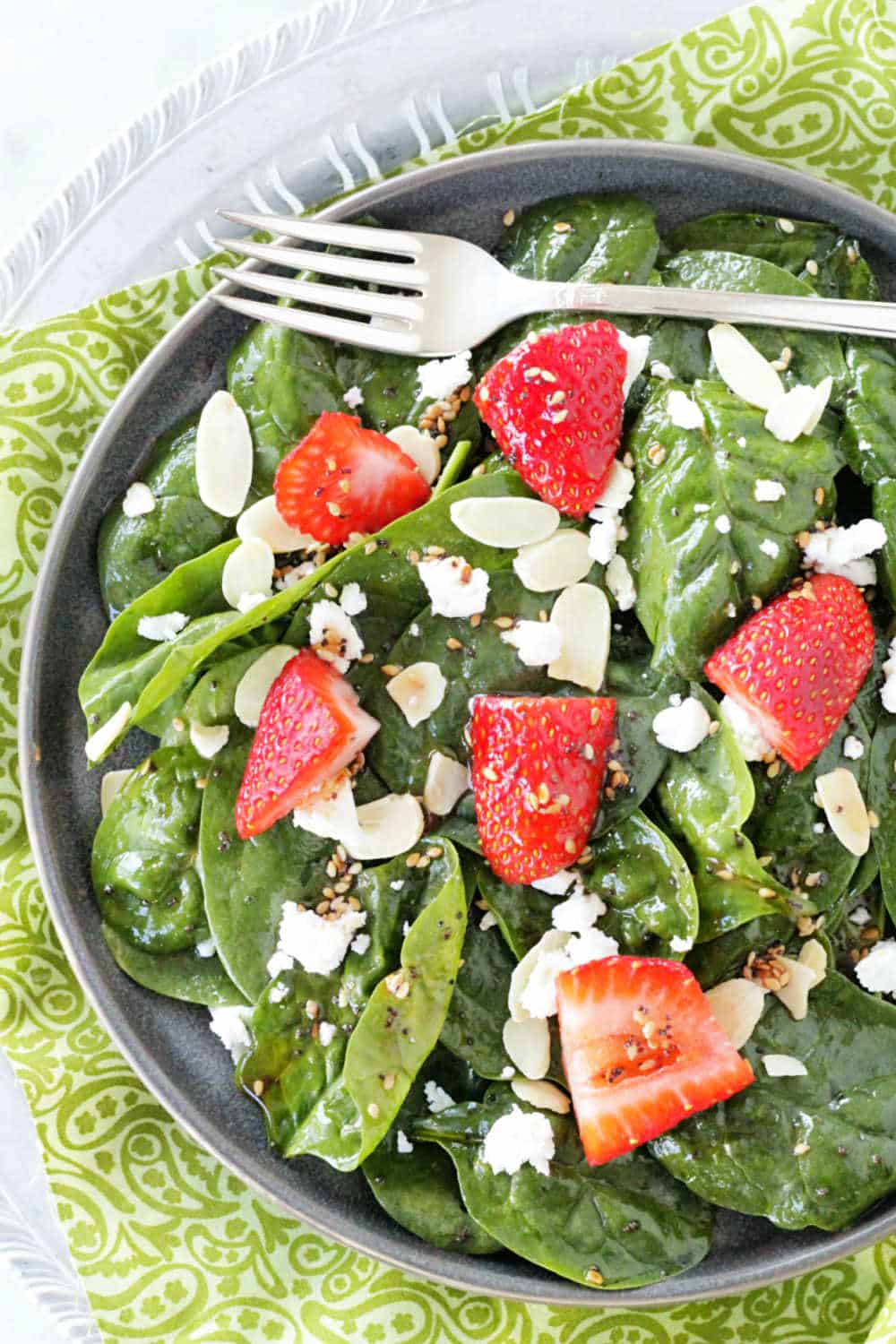 I've made this Spinach Strawberry Salad so many times I've lost count. It's always a crowd-pleaser. Fresh spinach, strawberries, goat cheese and sliced almonds are topped with a sweet and sour toasted sesame seed dressing. via @foodtasticmom