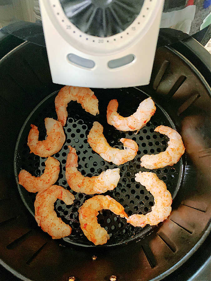 cooked shrimp in the basket of the air fryer