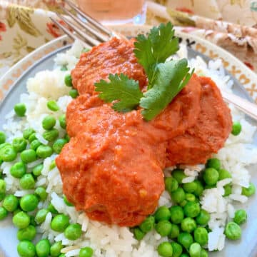 indian chicken butter meatballs plated with rice and peas