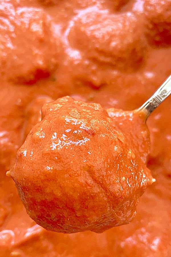 butter chicken meatballs on a spoon