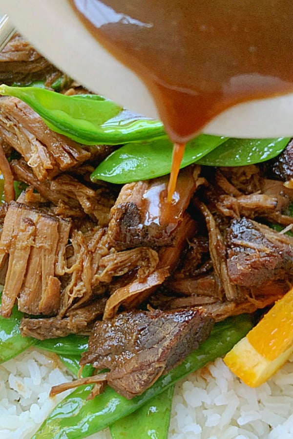 crispy crockpot orange beef sauce pouring