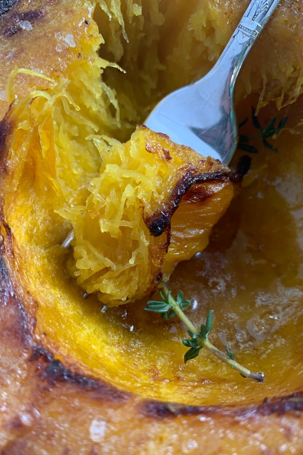 taking a bite of air fryer acorn squash