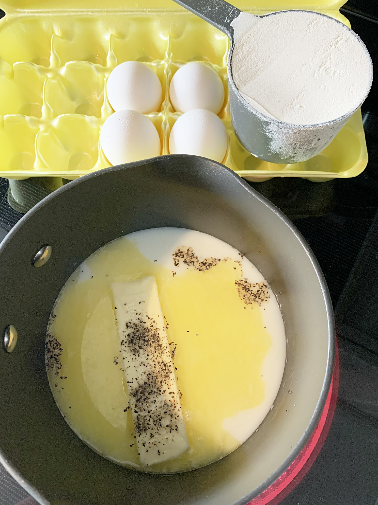 stovetop picture with eggs, flour, butter, milk