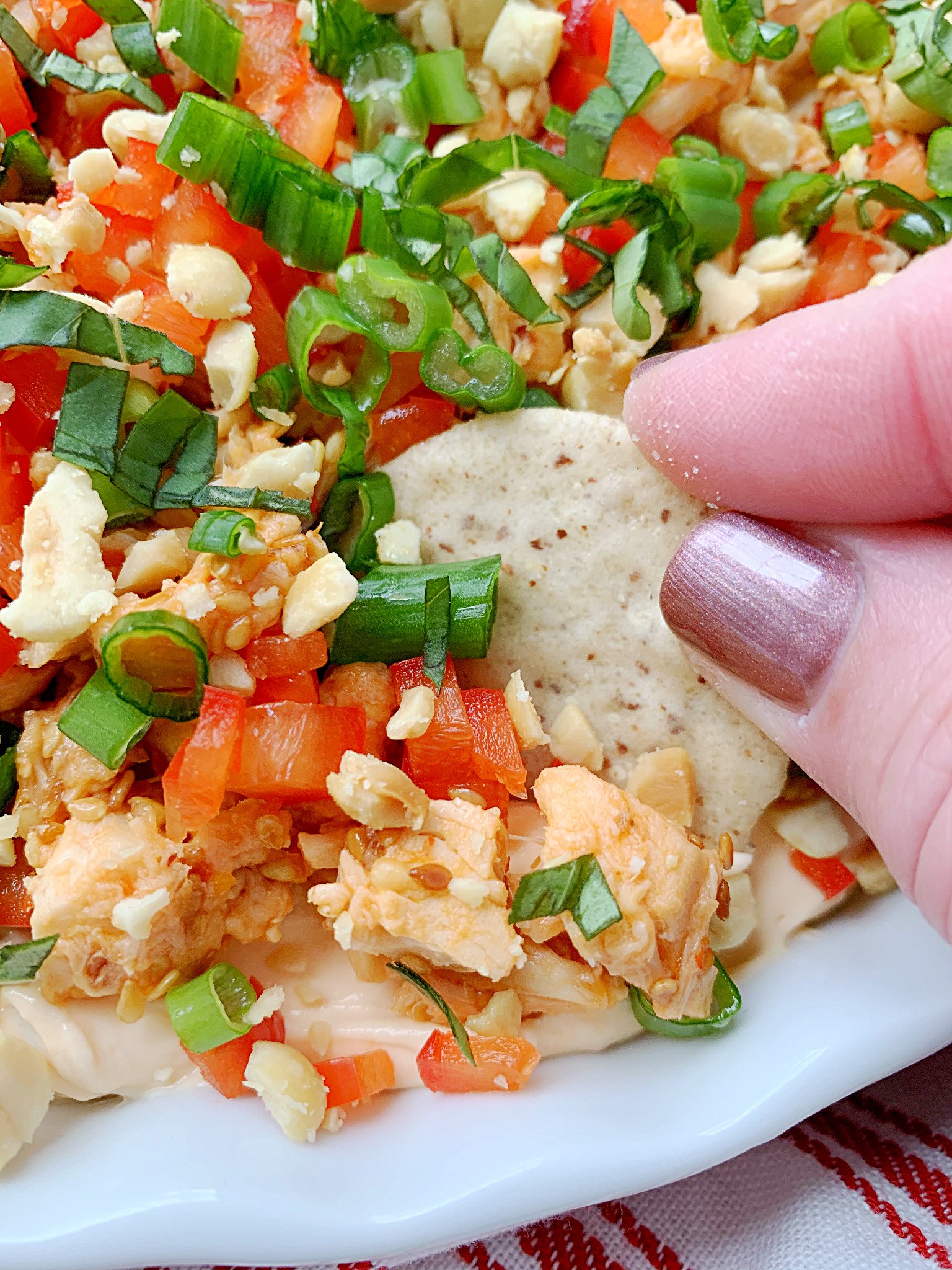 dipping a cracker into the thai dip