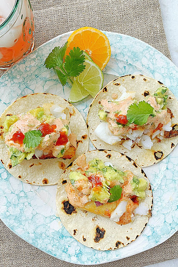 three air fryer fish tacos on a plate