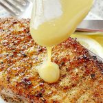 air fryer pork chops topped with maple dijon sauce