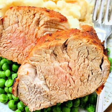 plated slices of air fryer pork tenderloin with mashed potatoes and peas
