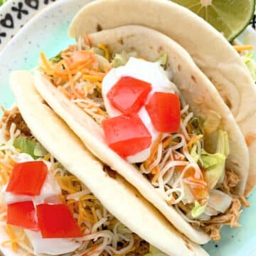 three crockpot chicken tacos on a plate