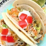 three plated slow cooker chicken tacos
