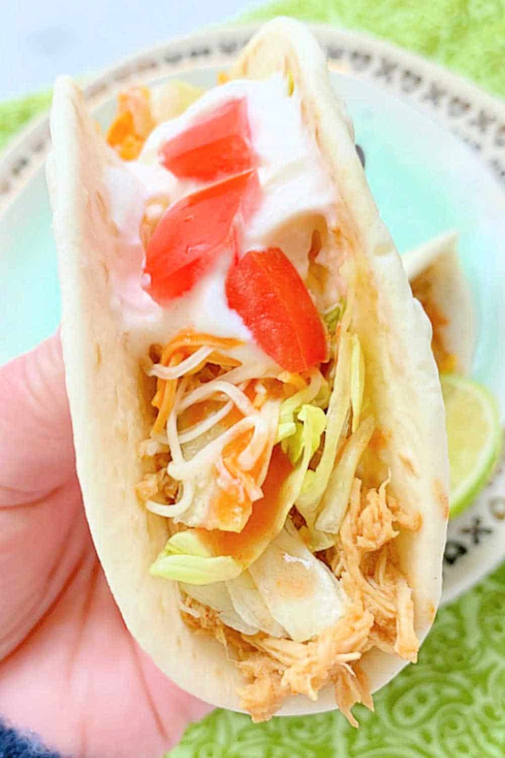 Crockpot Chicken Tacos are always a family-favorite meal. A few surprising ingredients make this shredded chicken taco filling irresistible. via @foodtasticmom