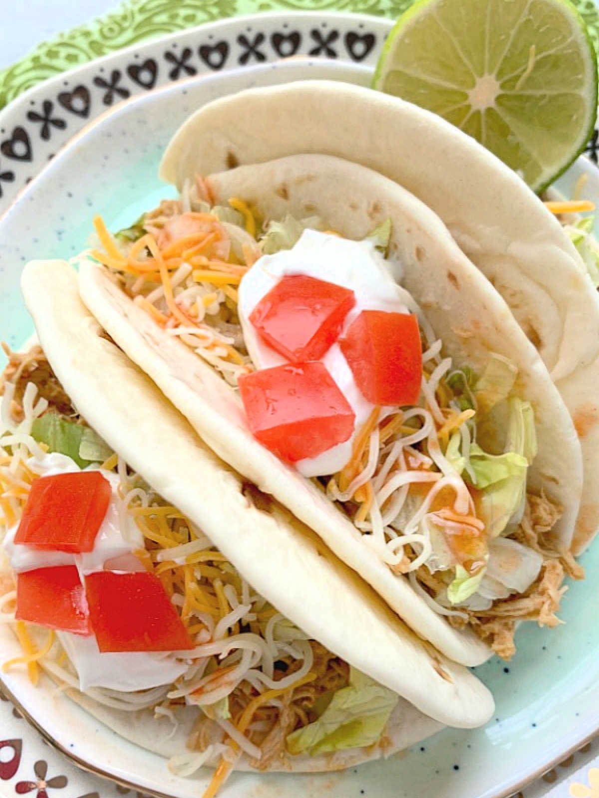 three plated crockpot chicken tacos