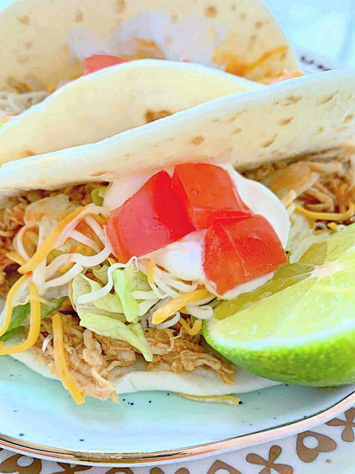 close up photo of a plated slow cooker chicken taco