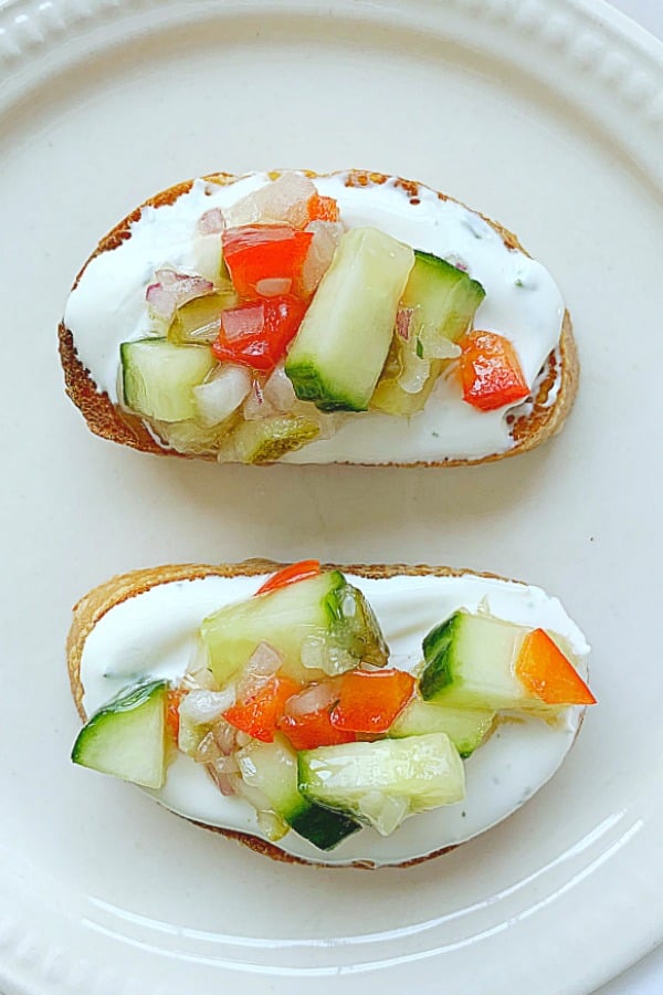 plate with two slice of cucumber bruschetta