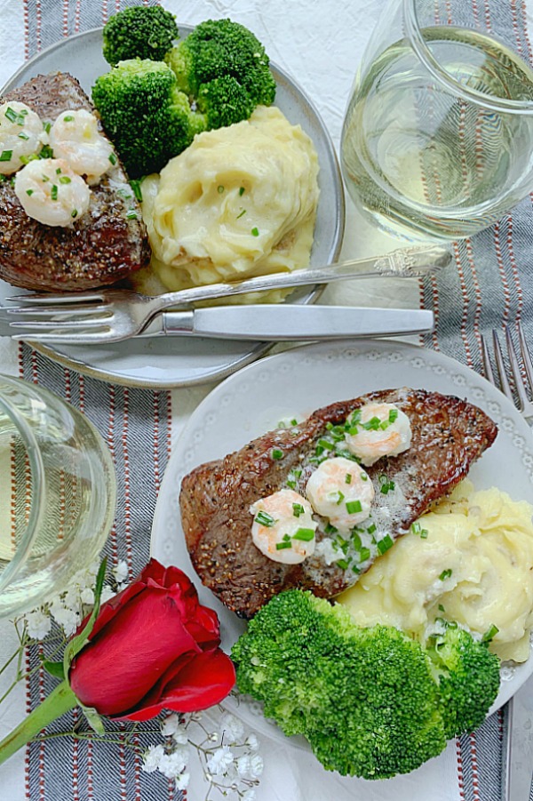 air fryer steak with shrimp cream sauce on plates with mashed potatoes and broccoli