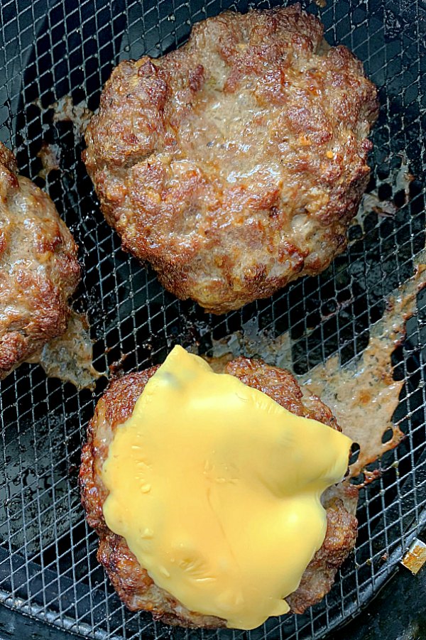 fully cooked burgers in the air fryer basket
