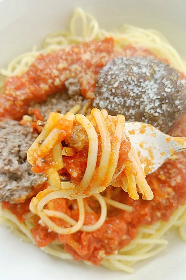 taking a bite of air fryer meatballs