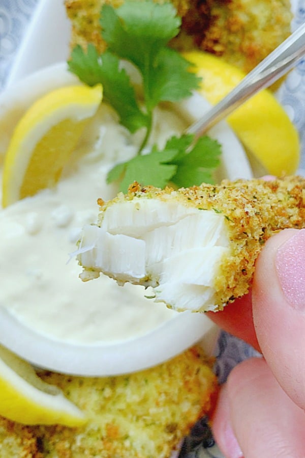 taking a bite of an air fryer fish stick