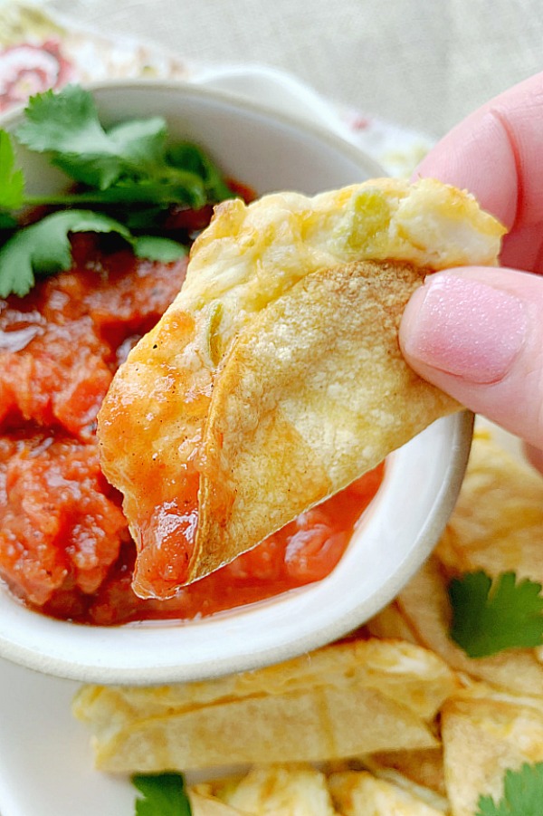 dipping mini tacos in salsa