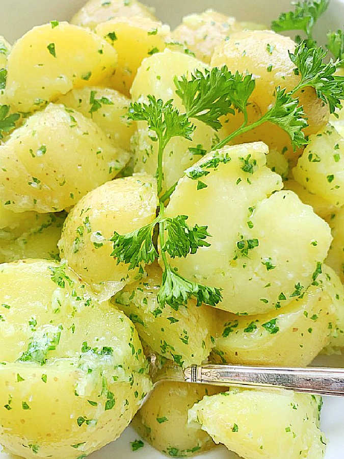 a bowl of parsley potatoes ready to serve