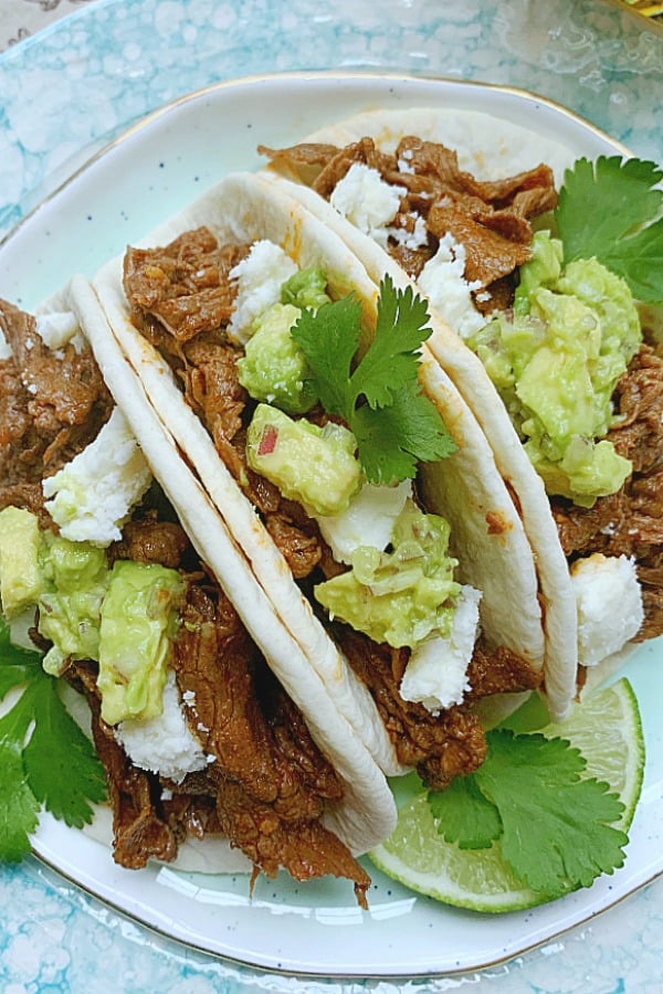 three steak tacos on a plate