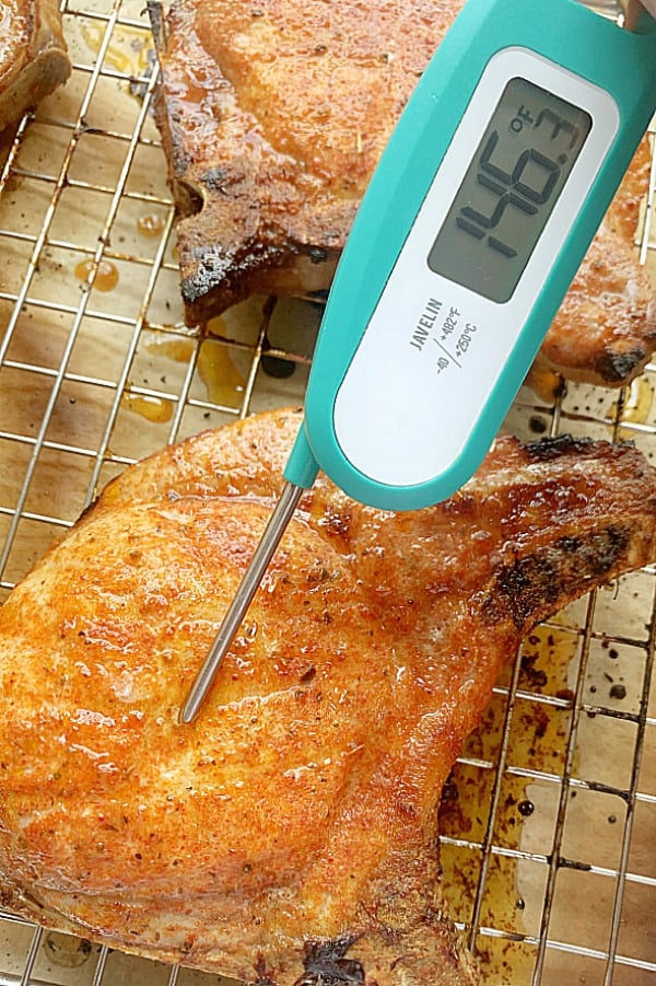 broiled pork with digital thermometer