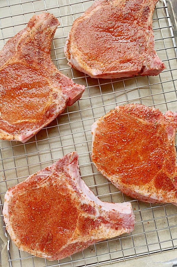 raw pork chops on sheet pan