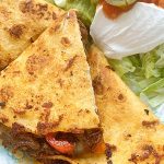 sliced steak fajita quesadillas on a plate