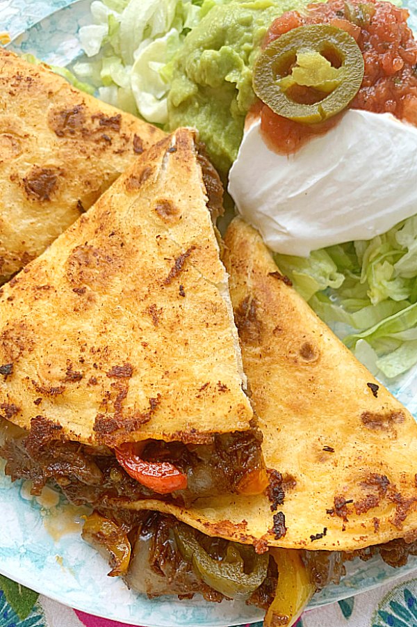 sliced steak fajita quesadillas on a plate