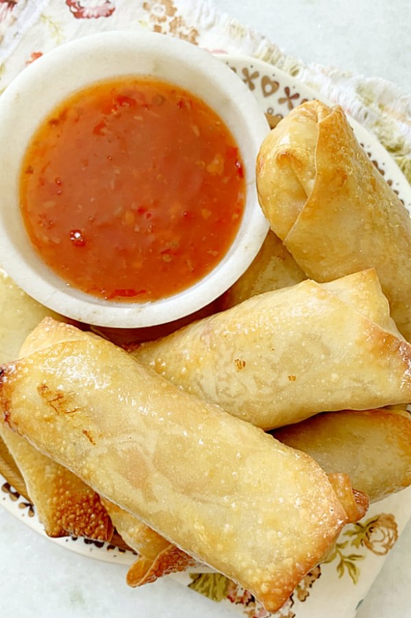 air fryer egg rolls on a plate with dipping sauce