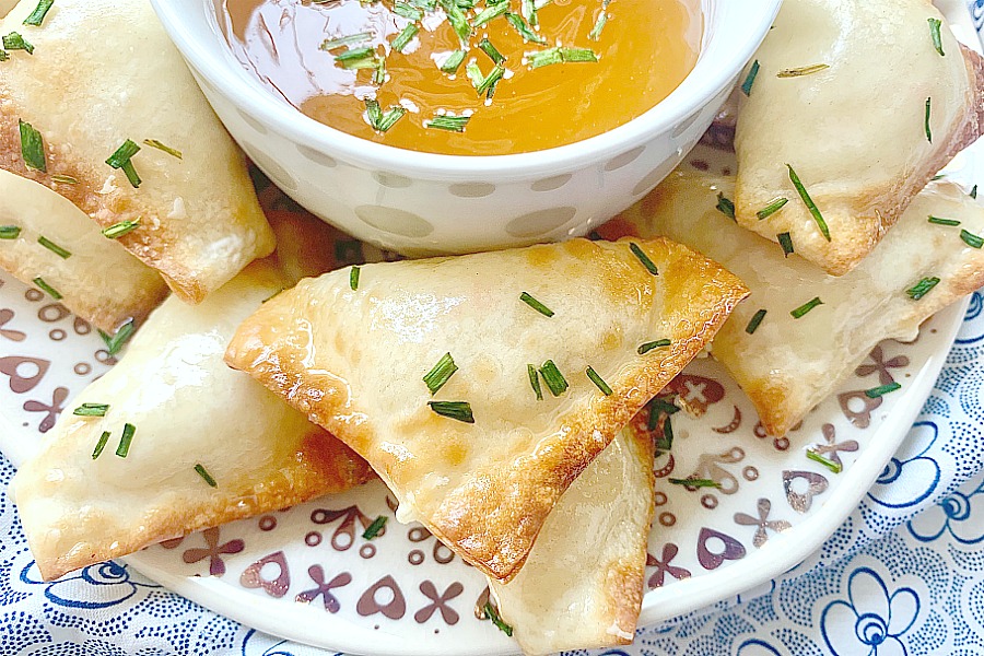 air fryer Crab Rangoon on a plate with dipping sauce