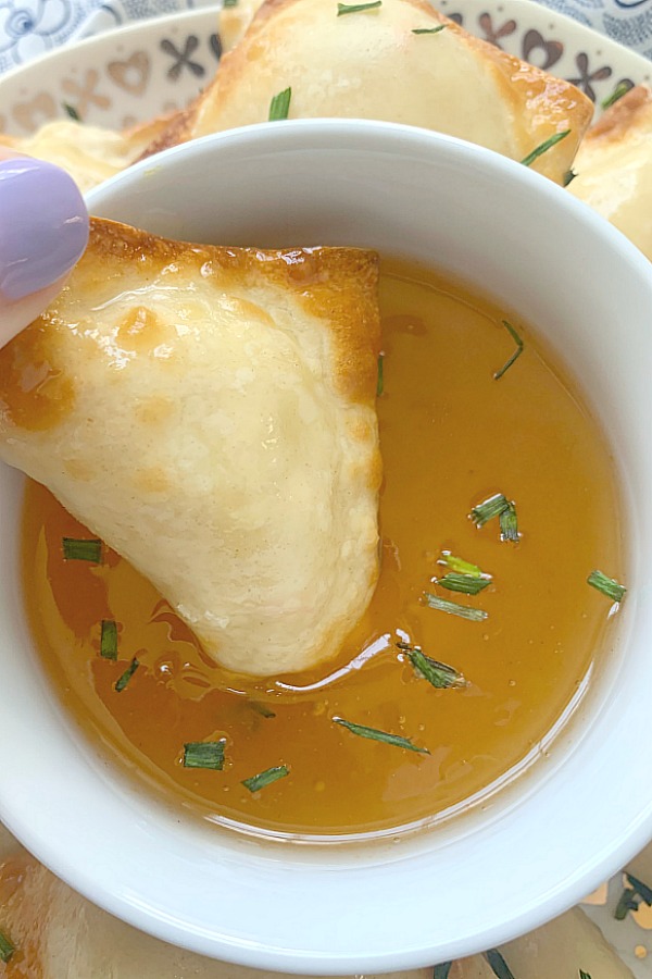 dipping a Crab Rangoon into duck sauce