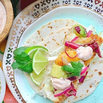 overhead view of open face fish taco garnished with lime