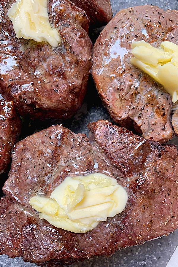 grilled steak topped with melted butter