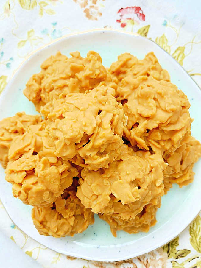 ten peanut butter cornflake cookies piled on a pretty turquoise plate