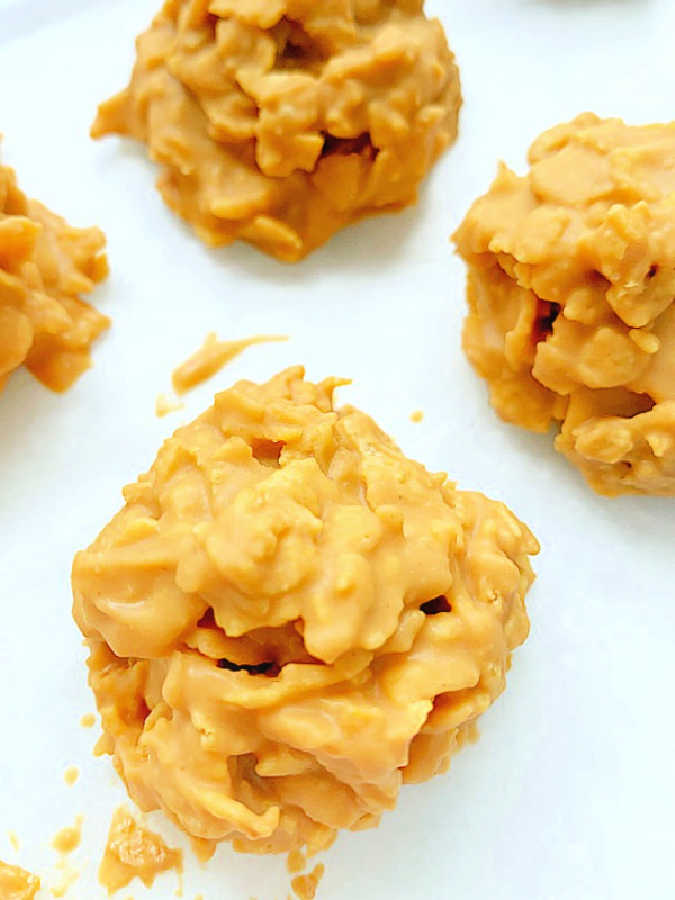 showing the cookies cooling on a wax paper lined baking sheet