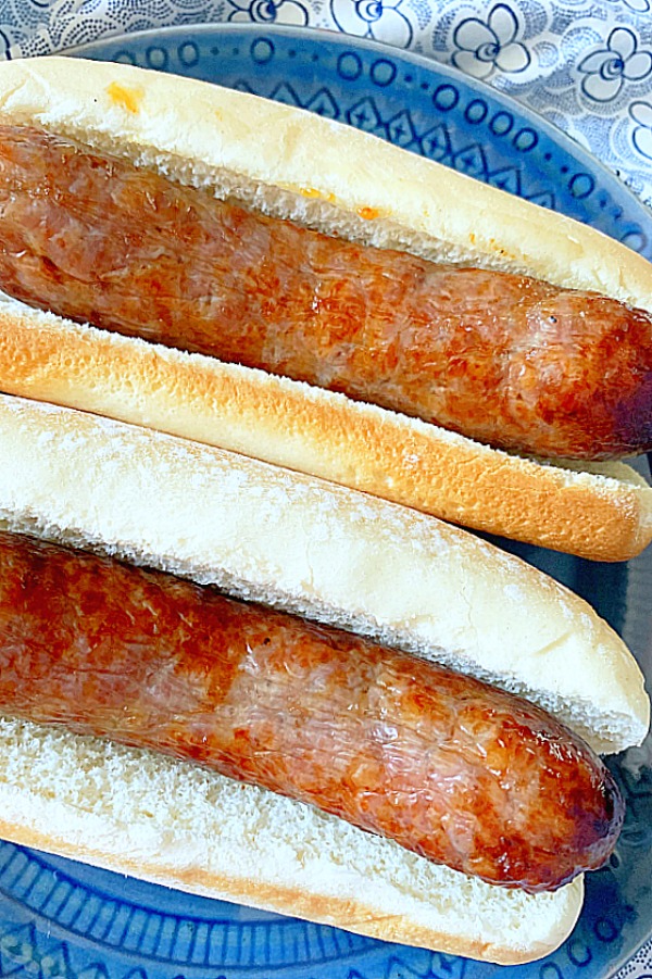 air fryer brats in hot dog buns on a plate