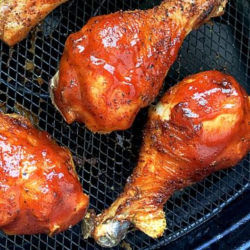 chicken legs with bbq sauce in the basket of the air fryer