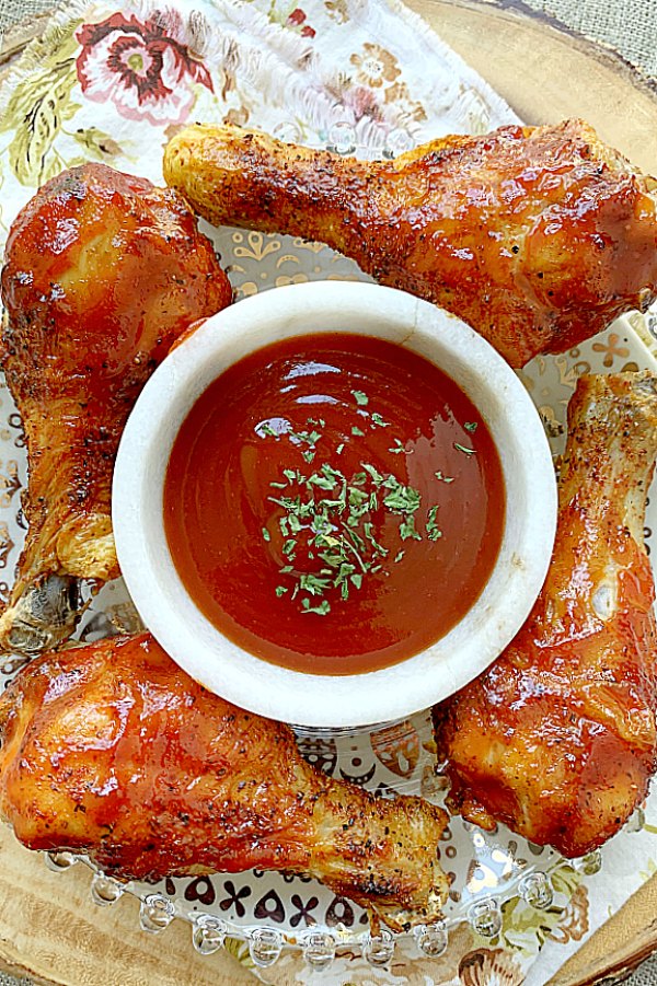 air fryer chicken legs plated with bbq sauce