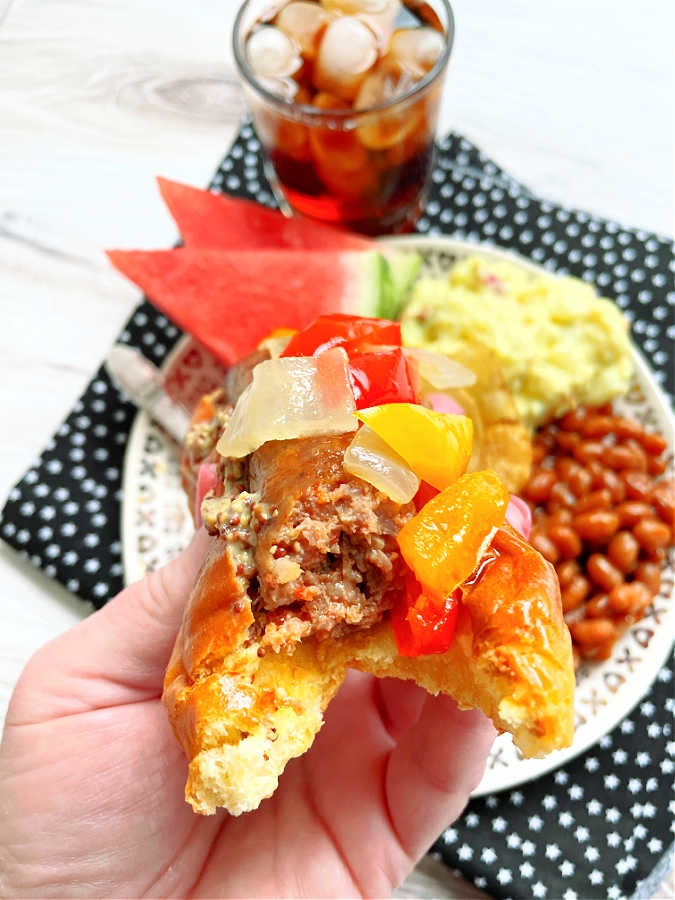 taking a bite of air fryer sausage