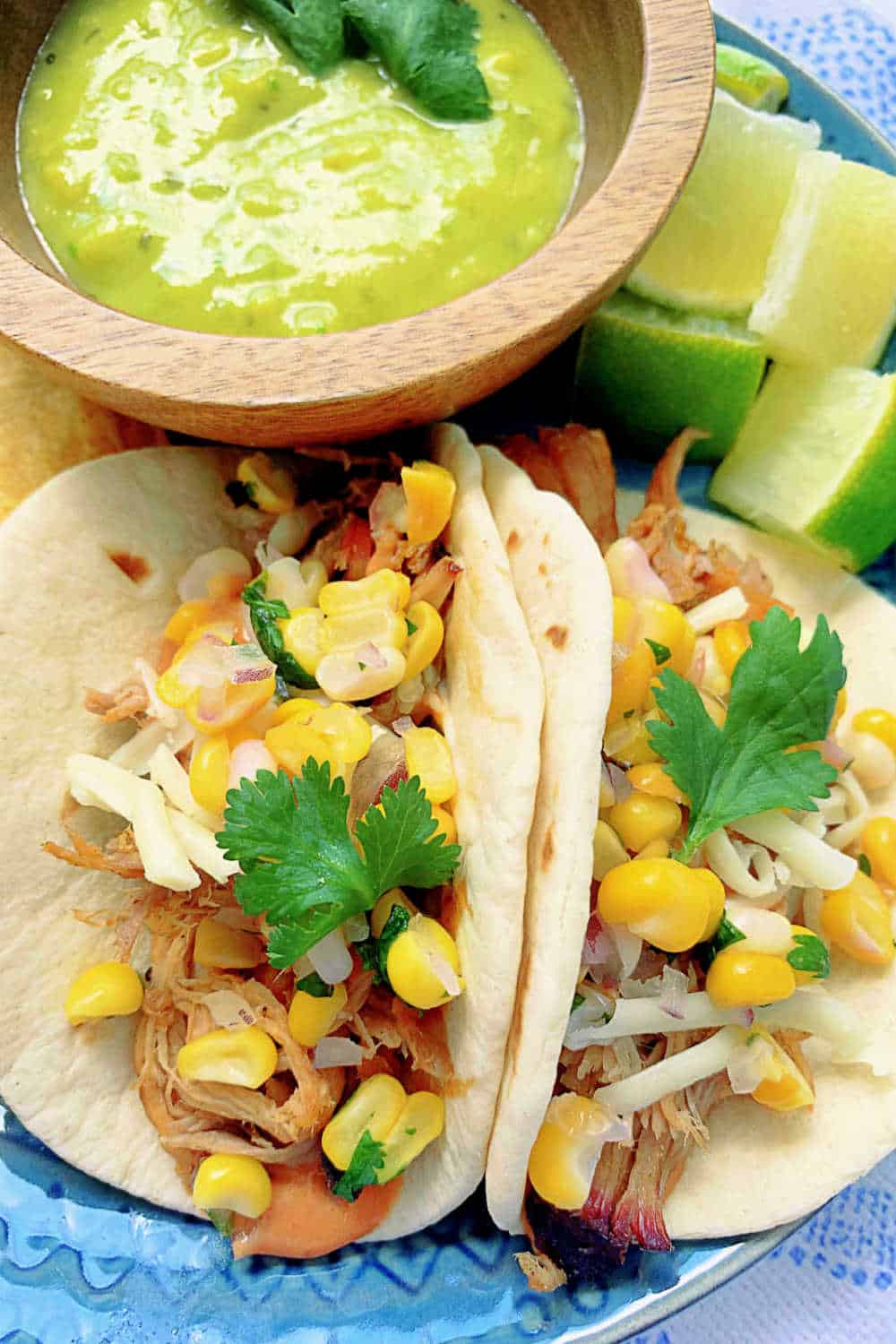Shredded pork, corn salsa, creamy chipotle BBQ sauce and warm tortillas combine in this great recipe for pulled pork tacos. via @foodtasticmom