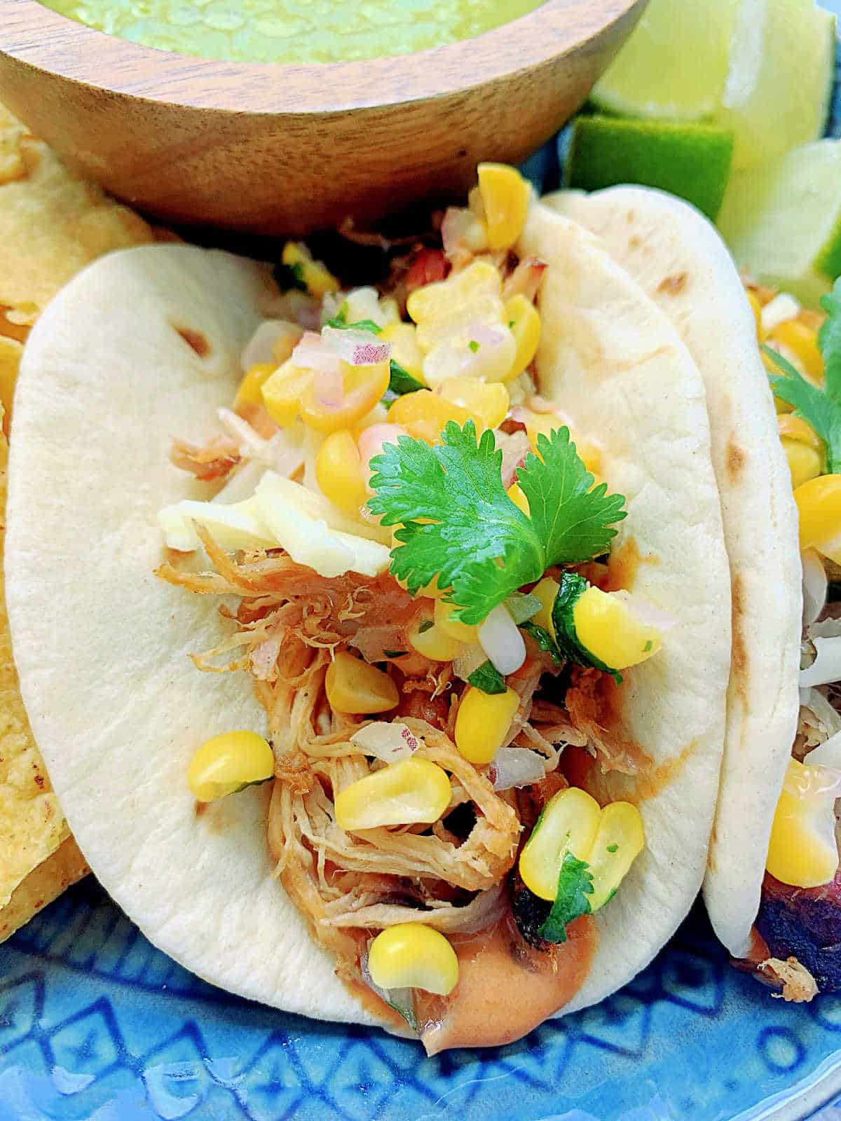 a plated pulled pork taco showing a close up of the filling