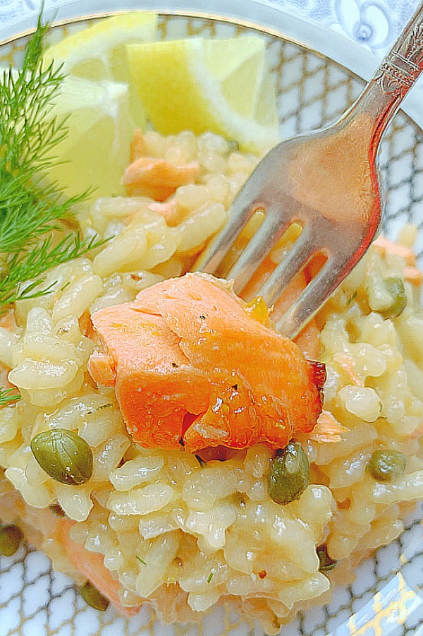 taking a bite of salmon from the salmon risotto