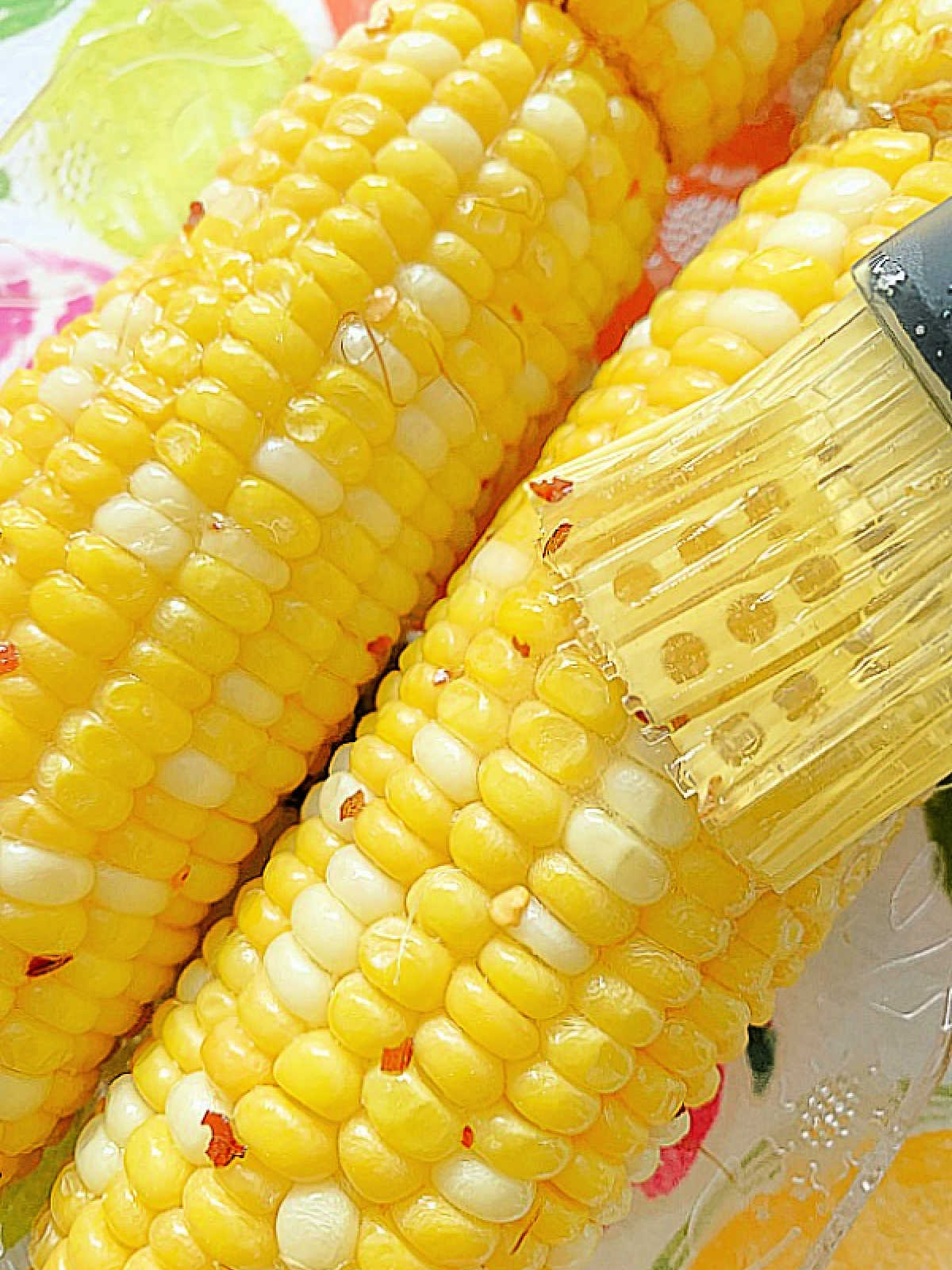 brushing the air fried corn with honey butter