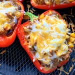 taco stuffed red bell peppers in the basket of the air fryer