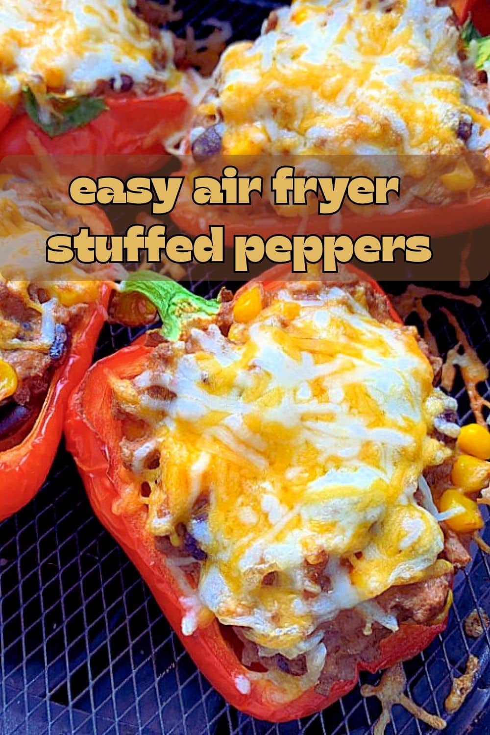 Air Fryer Stuffed Peppers are a wholesome meal for a busy weeknight. Red bell peppers stuffed with taco-seasoned ground beef. via @foodtasticmom
