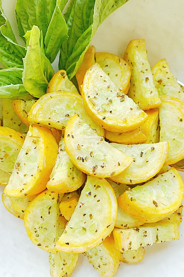 air fryer squash in a bowl with fresh basil