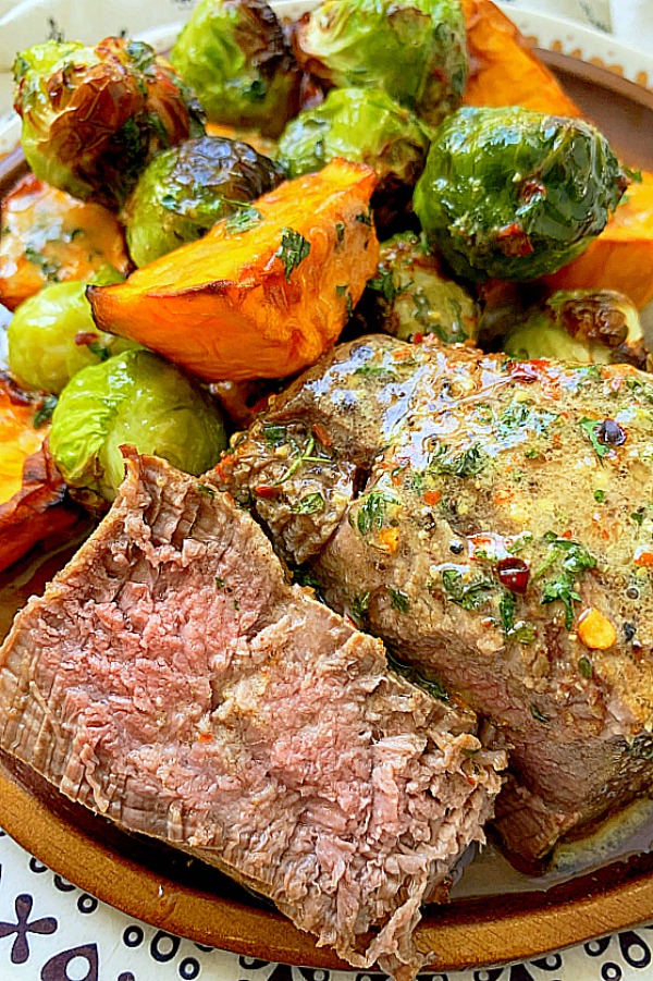 air fryer filet mignon cut in half to show the cook