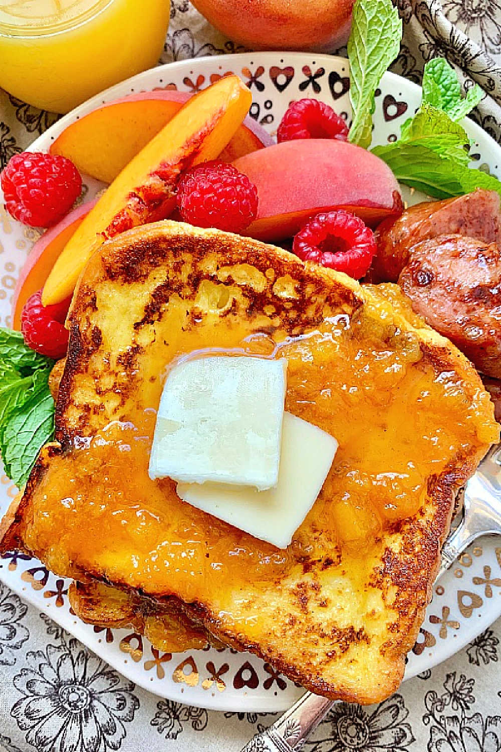 This Buttermilk French Toast topped with Peach Syrup is a main dish worthy of a fancy bed and breakfast but is really simple to prepare. via @foodtasticmom