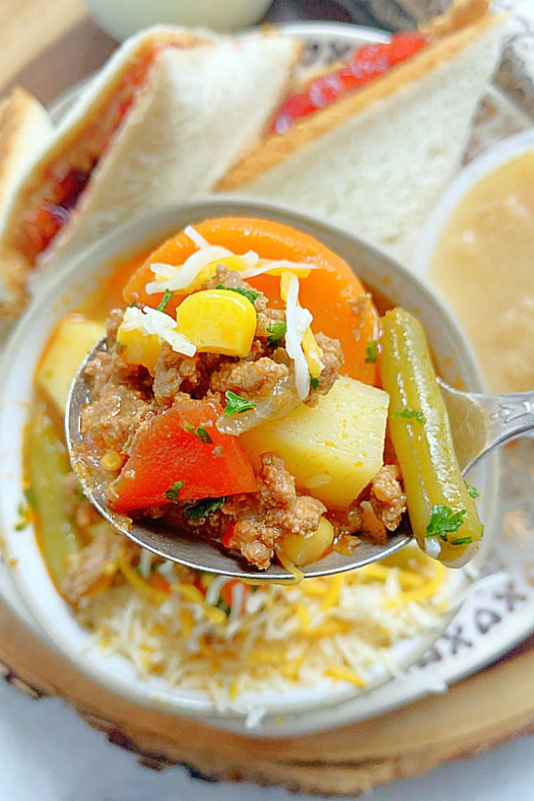 close up of a spoonful of campfire stew