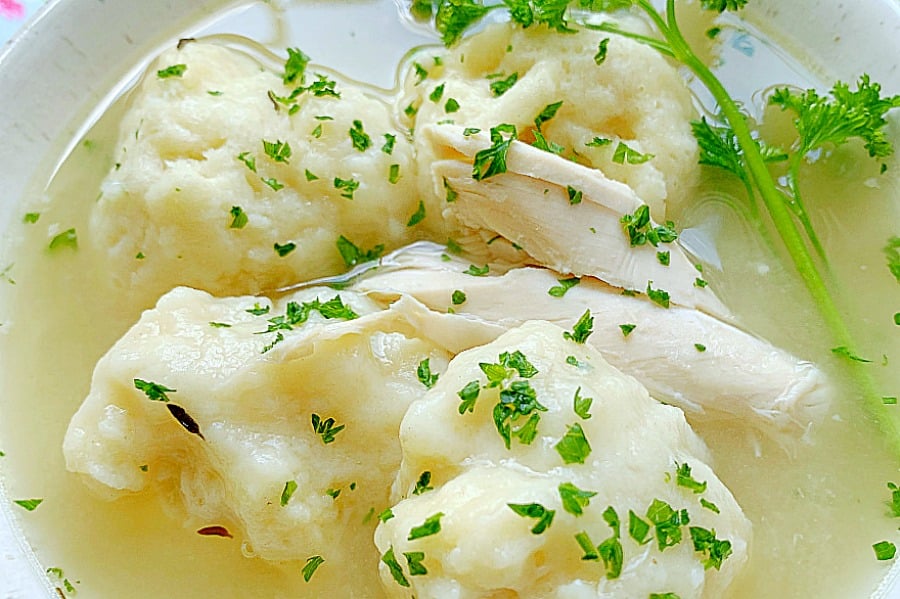 chicken and dumplings with broth in a bowl